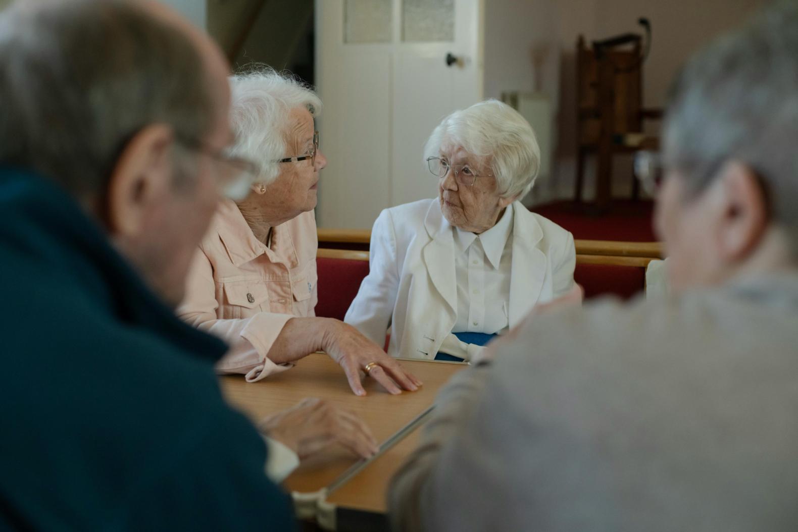 residents talking around a table