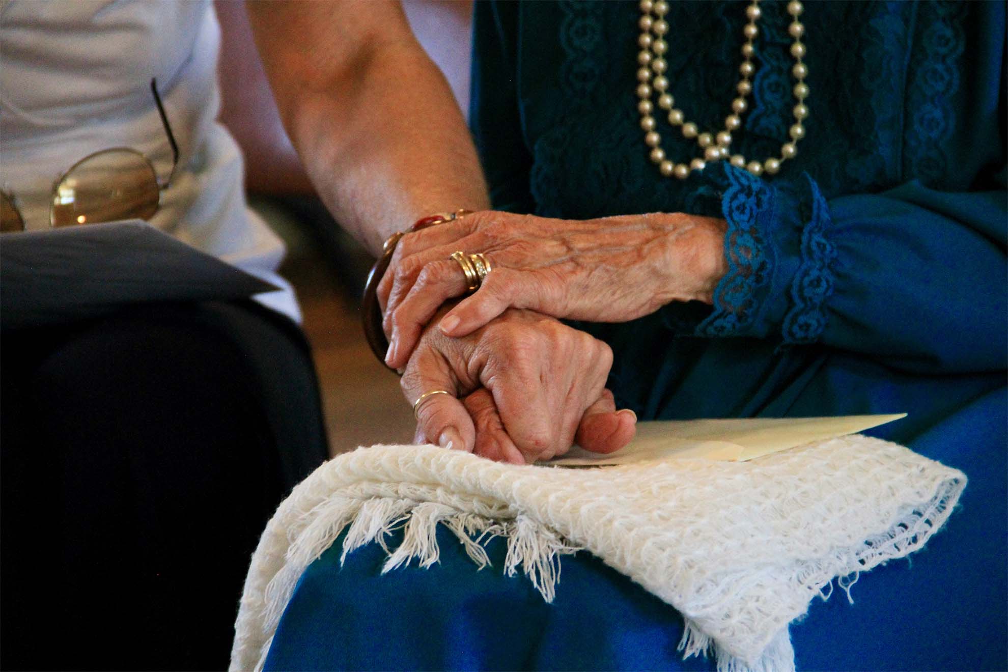 resident-and-care-worker-holding-hands