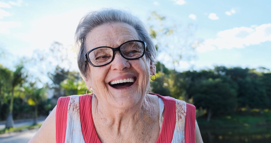 older woman smiling outside