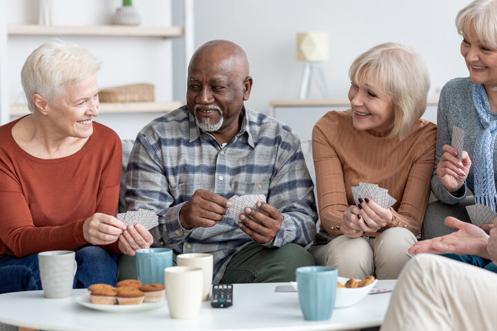 older people playing cards in respite care at a care home