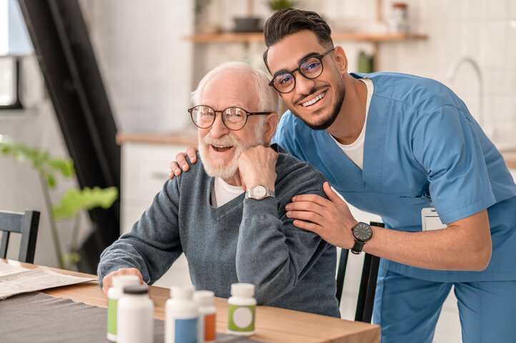 resident smiling with nurse in care home